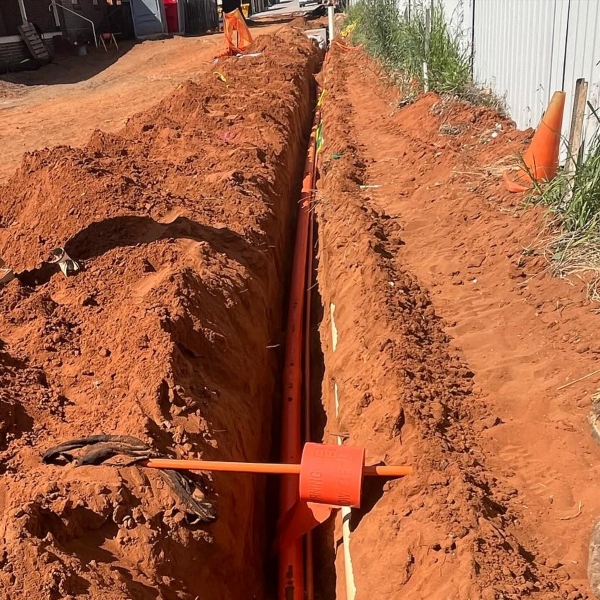 Underground electrical trench with orange conduit installation for new power service in Sydney by Dave Fenech Electrical Services