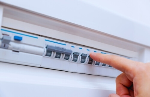 Dave Fenech Electrical Services electrician operating a household switchboard while performing electrical safety checks